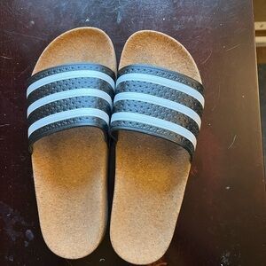 Woman’s cork sole Adidas slides.